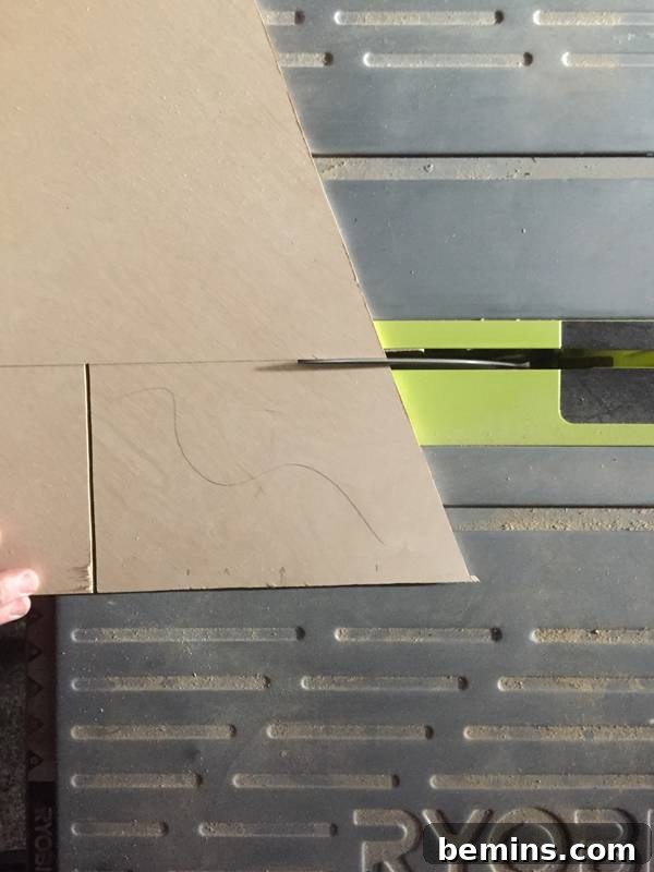 Cutting wood to make a Christmas tree, demonstrating the process of shaping the tree outline.