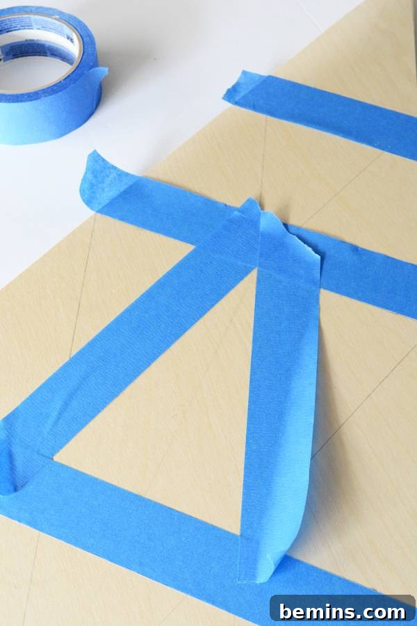 Cello tape is pasted on the sheet, showing the taping process for creating clean paint lines.