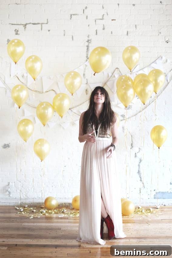 Woman in white dress with yellow party balloons - DIY Holiday Photo Backdrop