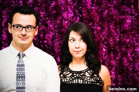 Couple standing next to each other with tinsel backdrop - DIY Holiday Photo Backdrop