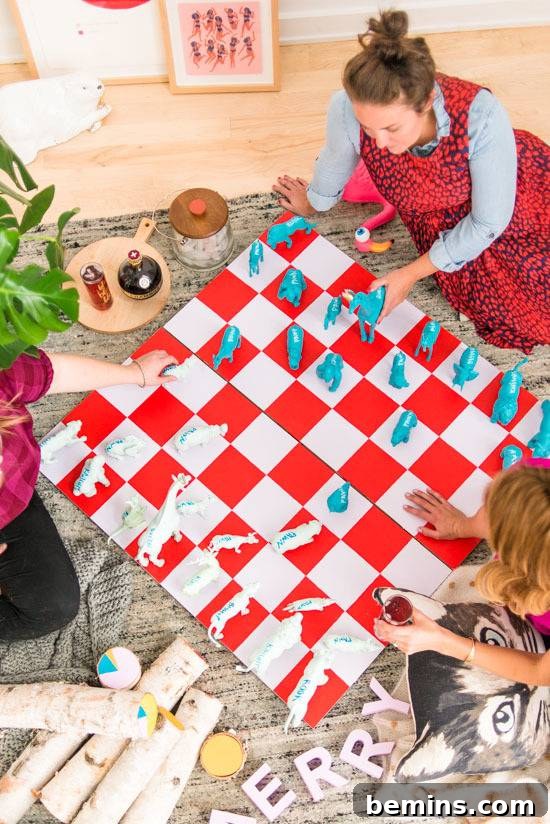 Woman playing chess with children on a giant chessboard