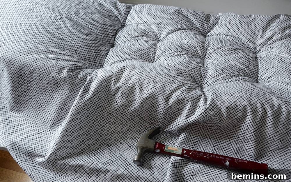 Hammering the nails to create the tufted effect