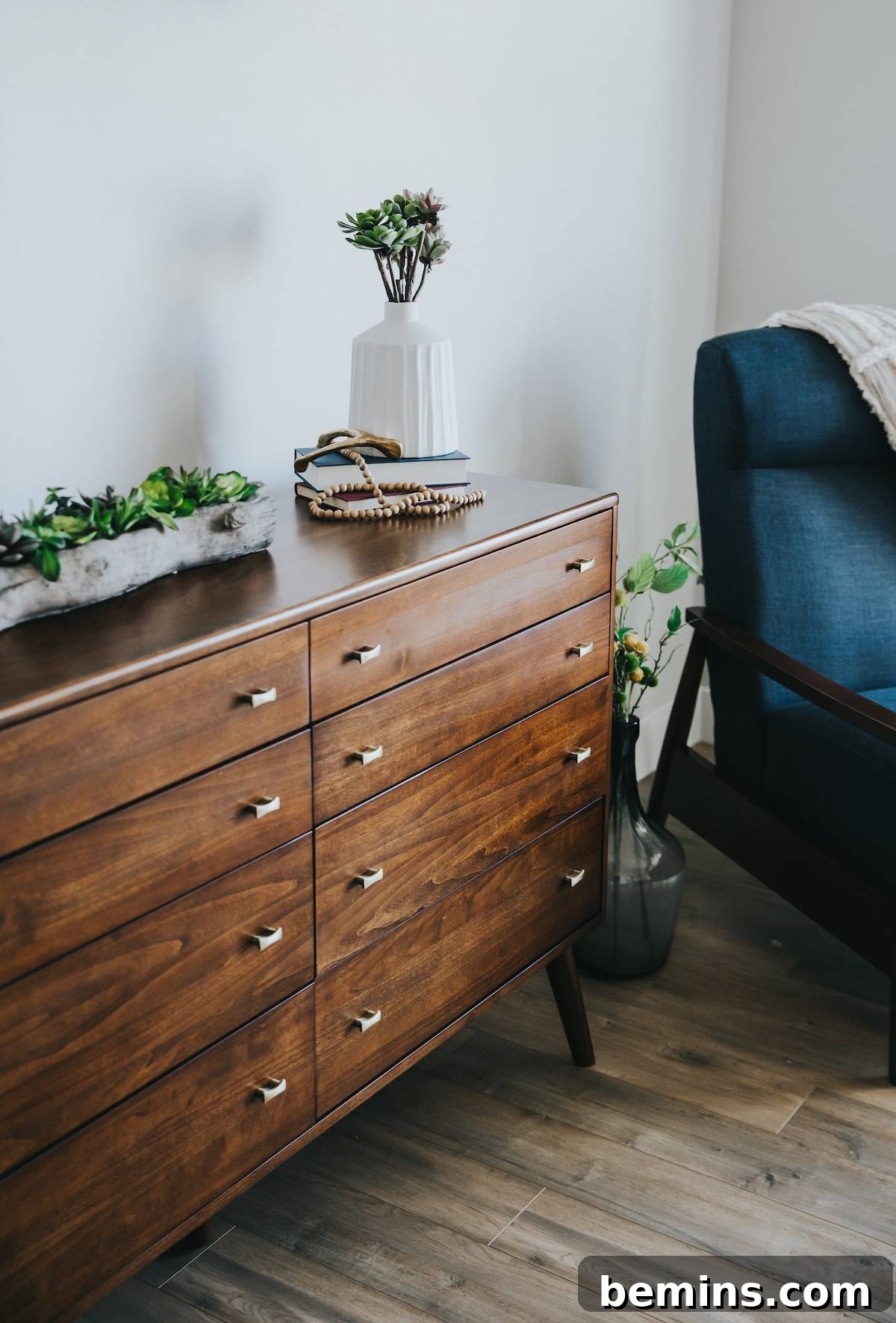 Well-lit room featuring a brown wooden dresser, perfect for showcasing drawer organization ideas.