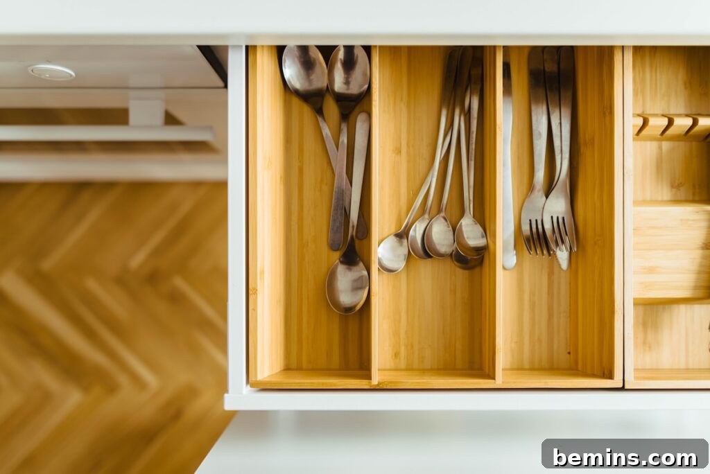 Utensils organized in a drawer, demonstrating efficient kitchenware organization with proper dividers and arrangement.
