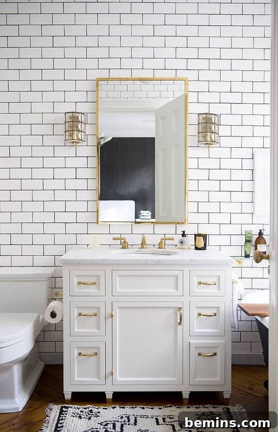 A white dresser set up against a tiled wall in a small bathroom.