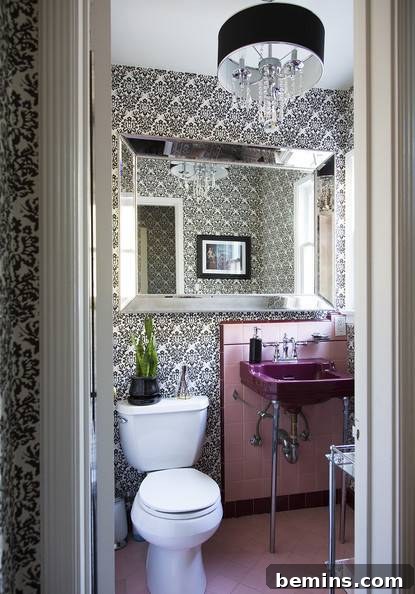 A bathroom with a large mirror extending beyond the sink.