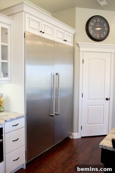 Modern kitchen with a large, built-in double-door stainless steel refrigerator