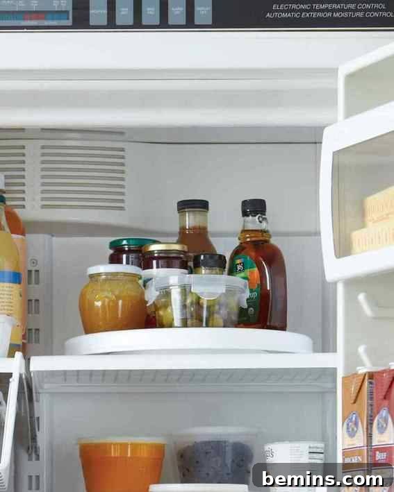 Drinks and bottles organized on a lazy Susan in the refrigerator