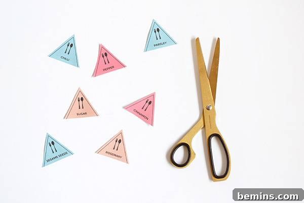 Scissors resting beside several triangular pieces of paper, suggesting the cutting and crafting process of creating labels.