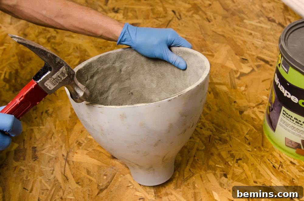 IKEA Upgrade: Crafting a Chic Concrete Pendant Light 11 Removing the mold with a hammer