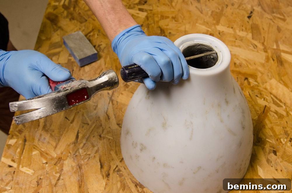 IKEA Upgrade: Crafting a Chic Concrete Pendant Light 13 Using a hammer to remove the mold