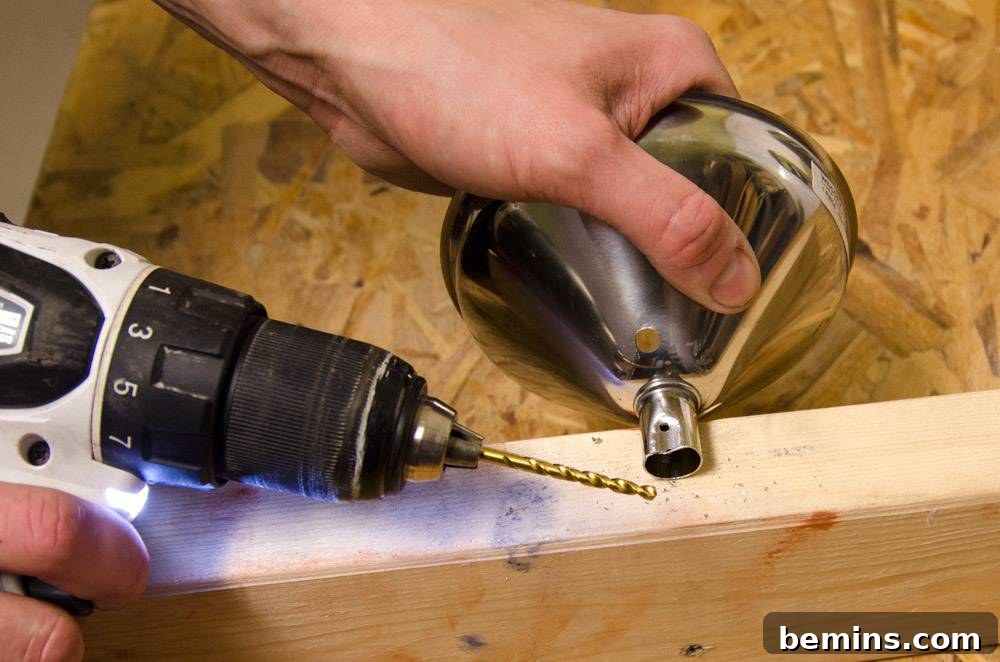IKEA Upgrade: Crafting a Chic Concrete Pendant Light 21 Drilling a hole in a piece of wood next to the funnel