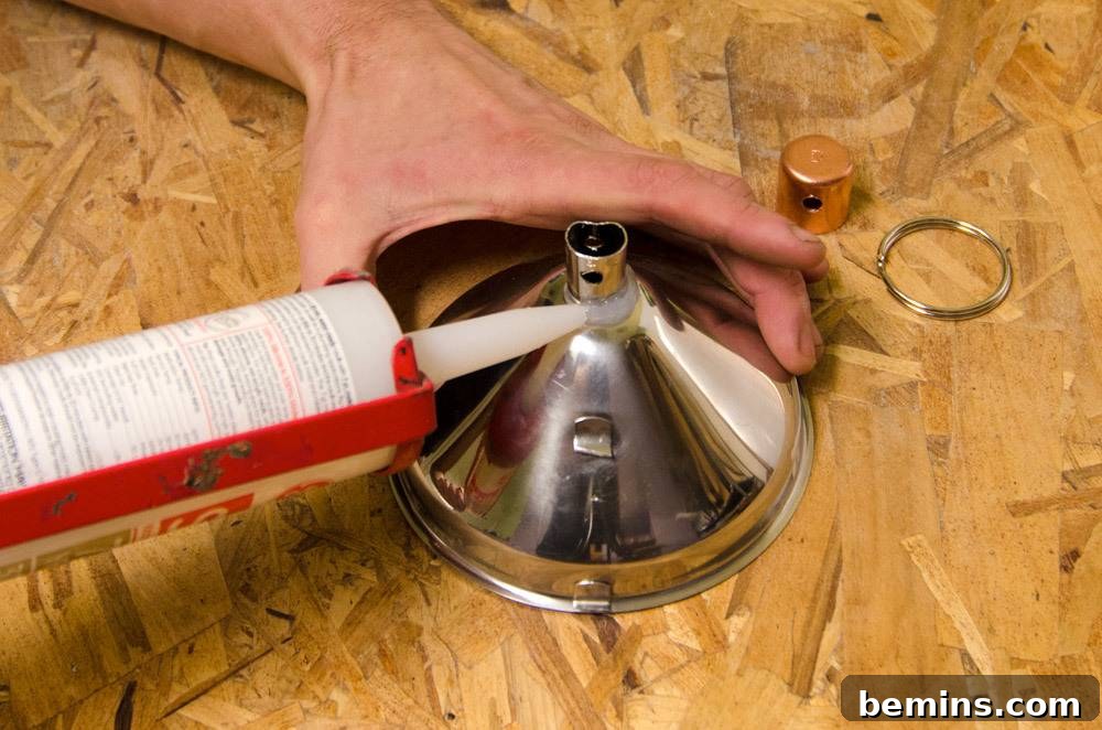 IKEA Upgrade: Crafting a Chic Concrete Pendant Light 24 Applying caulk to the silver part