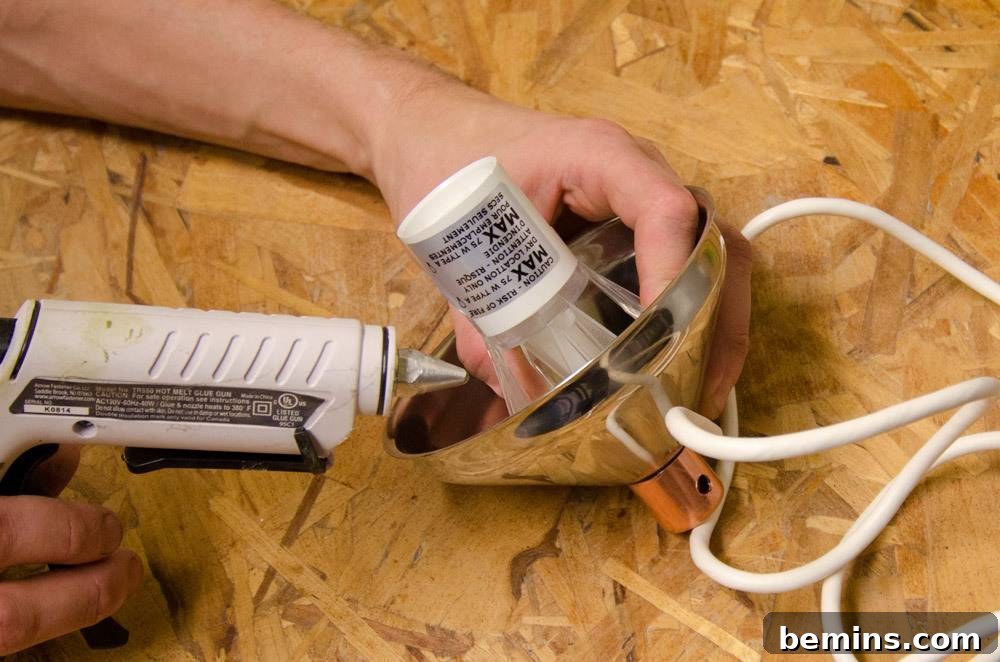 IKEA Upgrade: Crafting a Chic Concrete Pendant Light 26 Using a tool on the silver object