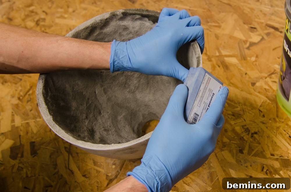 IKEA Upgrade: Crafting a Chic Concrete Pendant Light 10 Sanding the edge of the concrete pendant