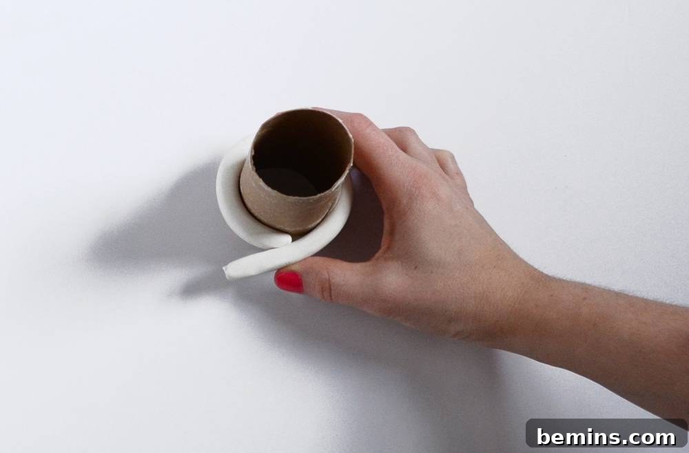 Wrapping the clay around a toilet paper roll