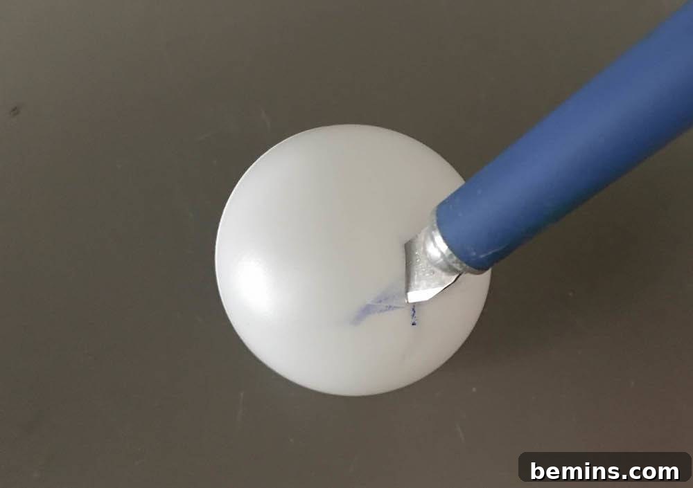 Cutting X on ping pong balls