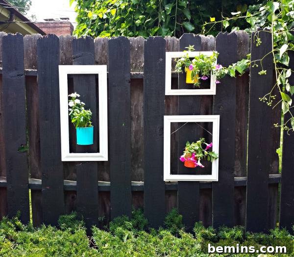 Patios with a spring vibe featuring framed potted plants on a fence