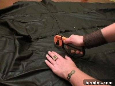Sewing with a hand-held sewing machine.