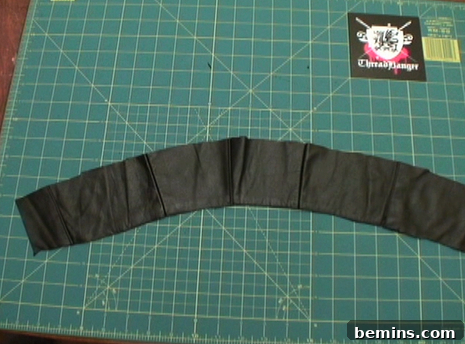 Narrow sleeve of fabric on a green surface.