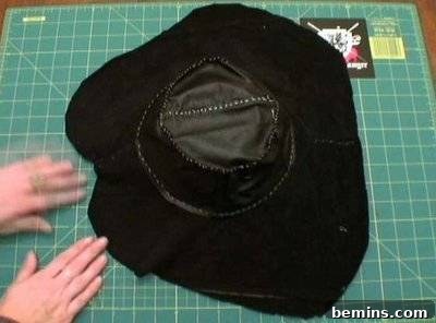 A pirate costume being held up in black fabric.