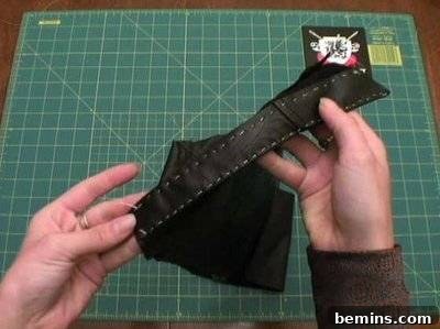 A person holding black leather for a pirate costume.