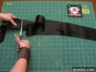 A person cutting black ribbon.