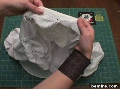 A person holding a white piece of fabric.