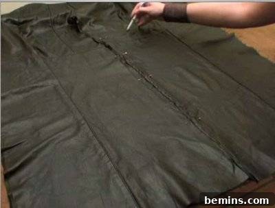 Black fabric being marked.