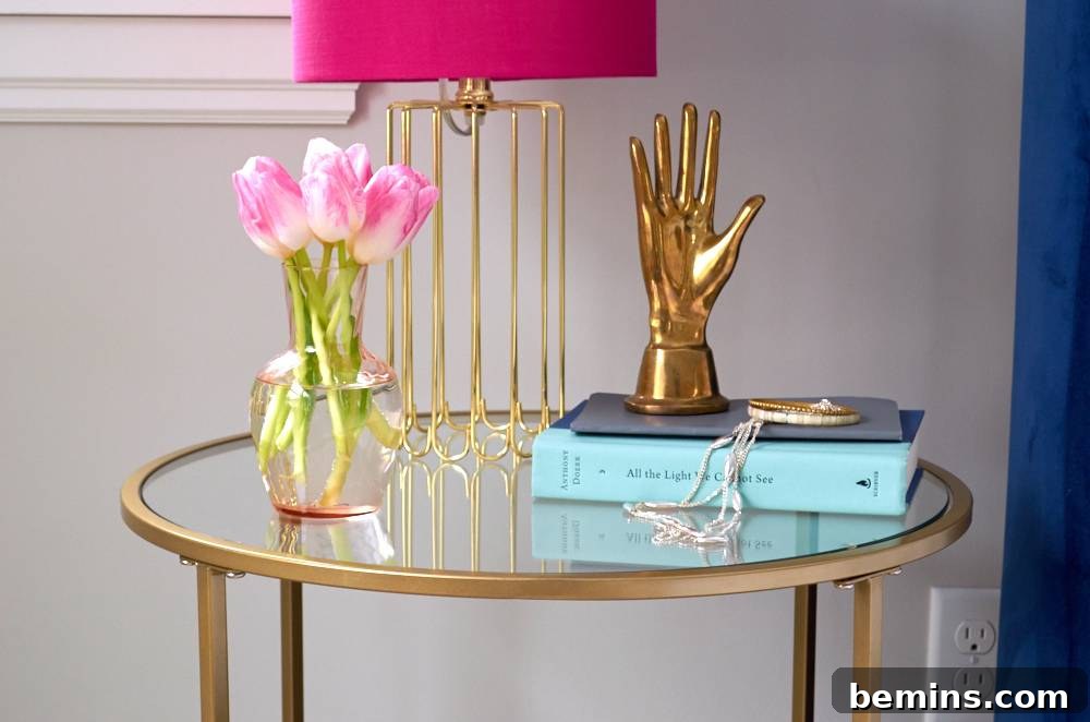 Glass table nightstand with hand statue, night lamp, and flower pot