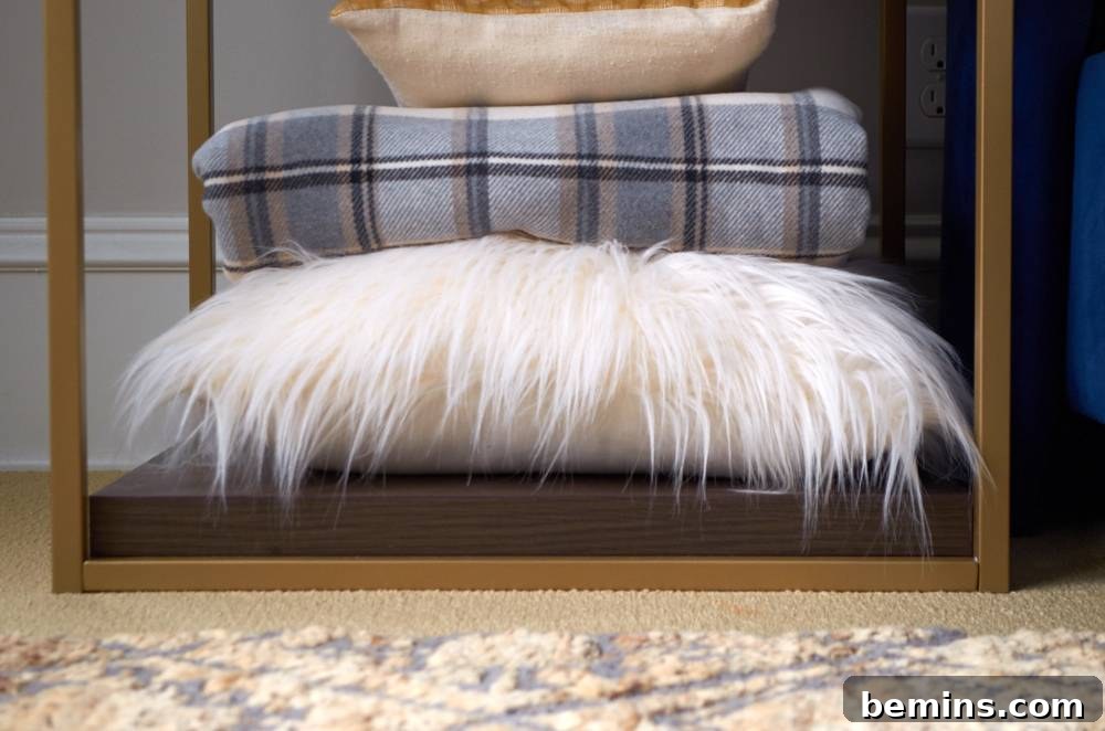 Pillows stacked on the floor near a small table