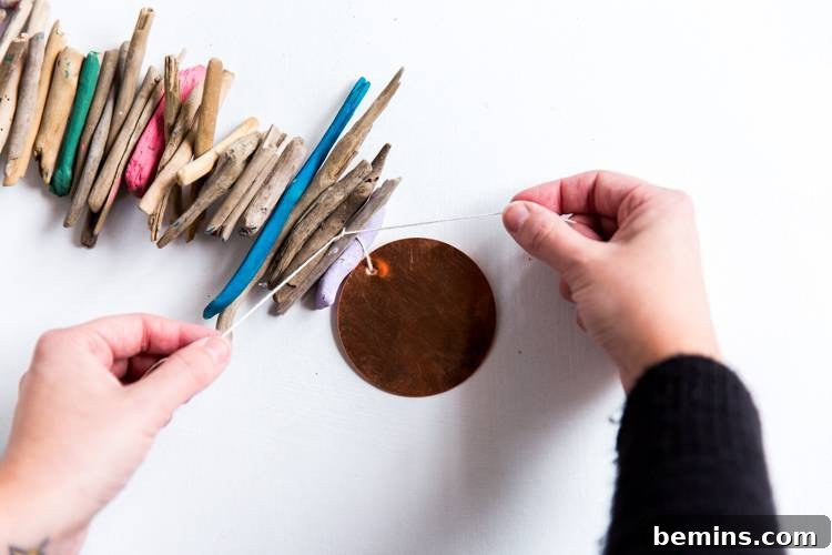 Driftwood Dreams: Crafting a Coastal Hanging Mobile 6 Attaching Copper Rounds to Driftwood