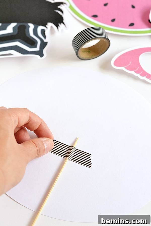 Attaching sticks to photo booth props