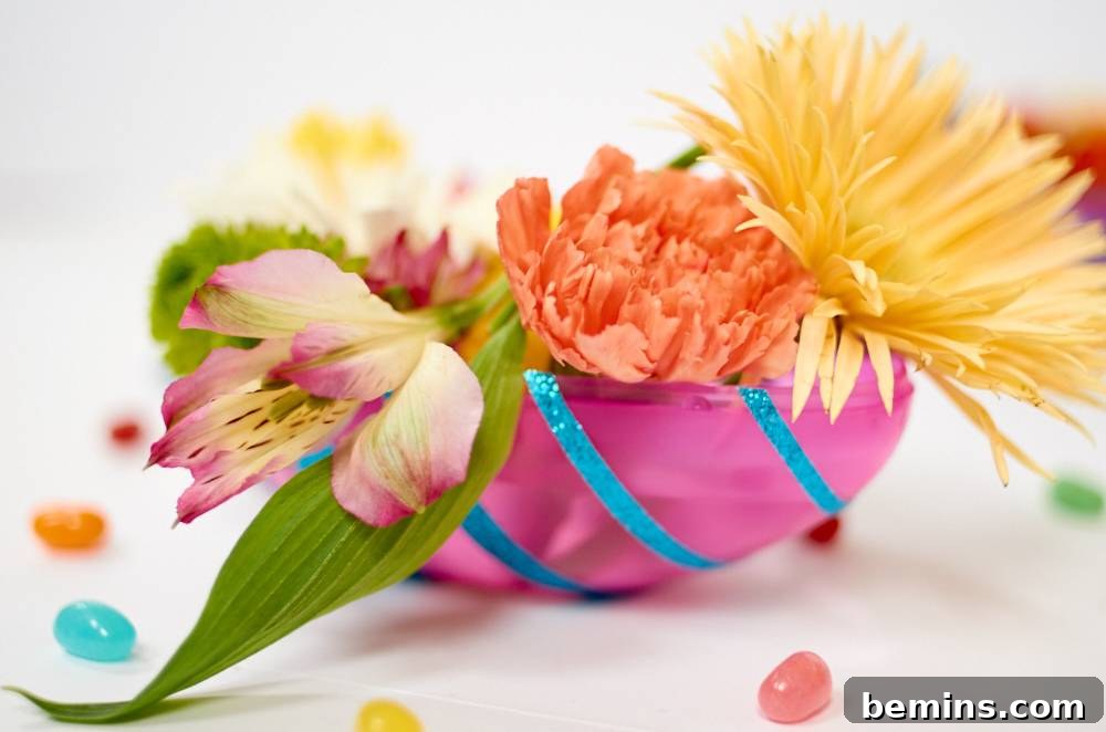 Three big flowers peeking out from a dark pink, blue striped pouch.