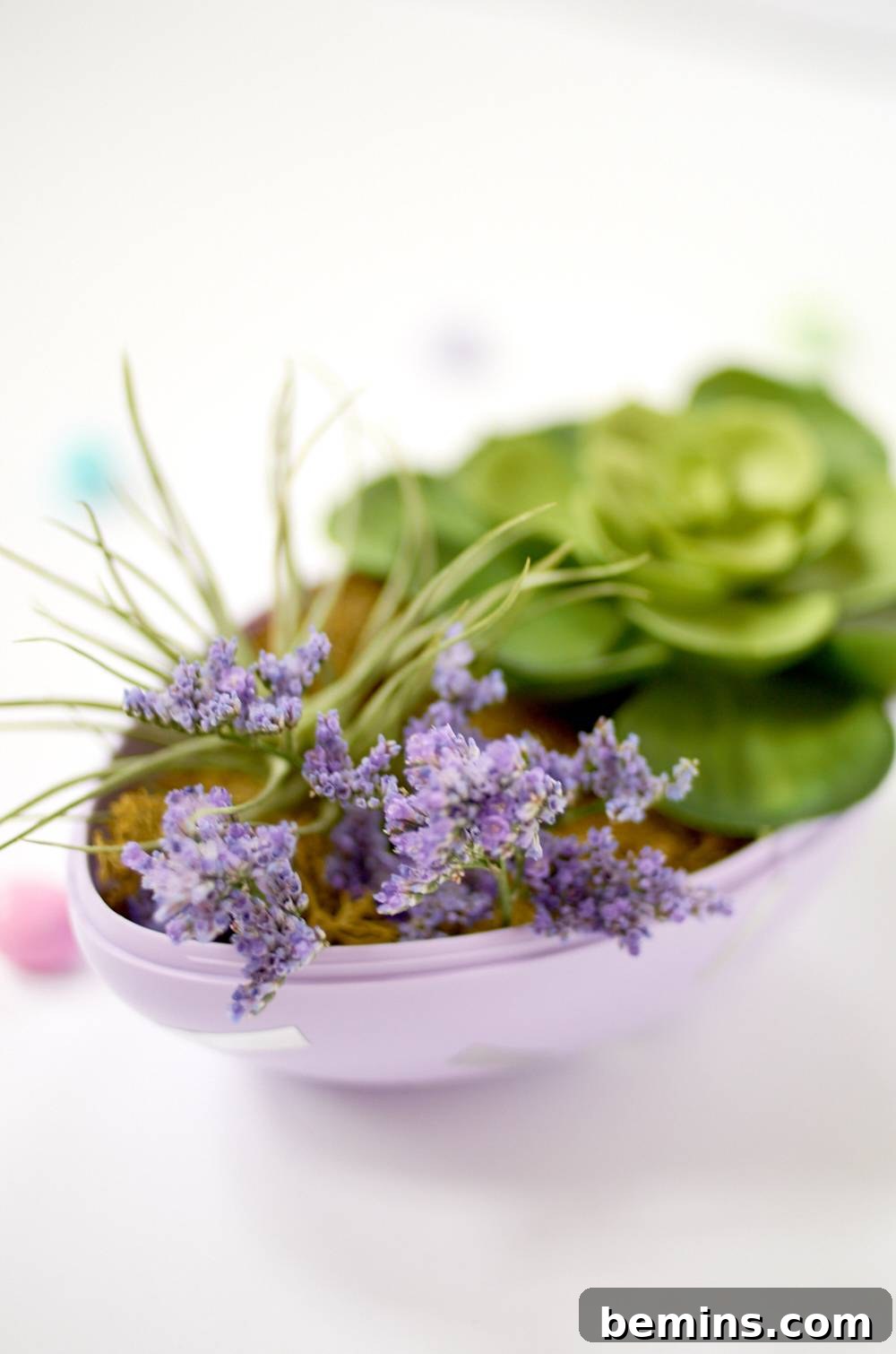 A bowl with purple flowers and green food inside.