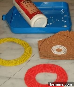 Basic crafting supplies laid out on a table, including thread, beads, glue, and a paintbrush, essential for DIY seed bead projects.