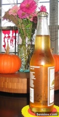 A finished candy corn seed bead coaster holding a cool beverage, demonstrating its functional and decorative appeal for home use.