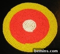 A vibrant candy corn themed seed bead coaster, showcasing the intricate beadwork and color gradient, a perfect fall decoration.