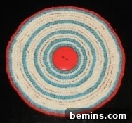 A seed bead coaster featuring a button as its central element, demonstrating an alternative design approach with a cleaner finish.