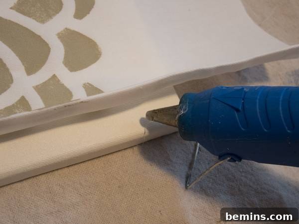 Gluing the bottom hem of the fabric to the canvas