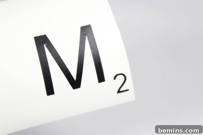 The design for the letter M and the number 2, representing a Scrabble tile, is displayed on a screen.