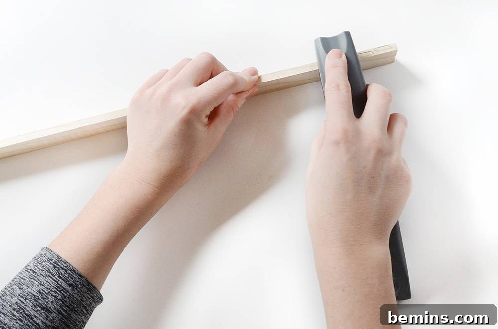 Adding staples to the bottom edge of the wood