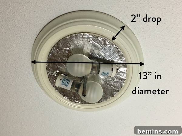 Existing light fixture with the glass shade removed.