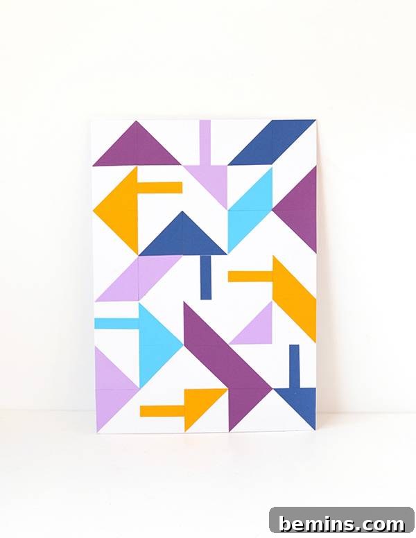 Finished DIY geometric paper wall art displayed elegantly on a white wall, ready for framing