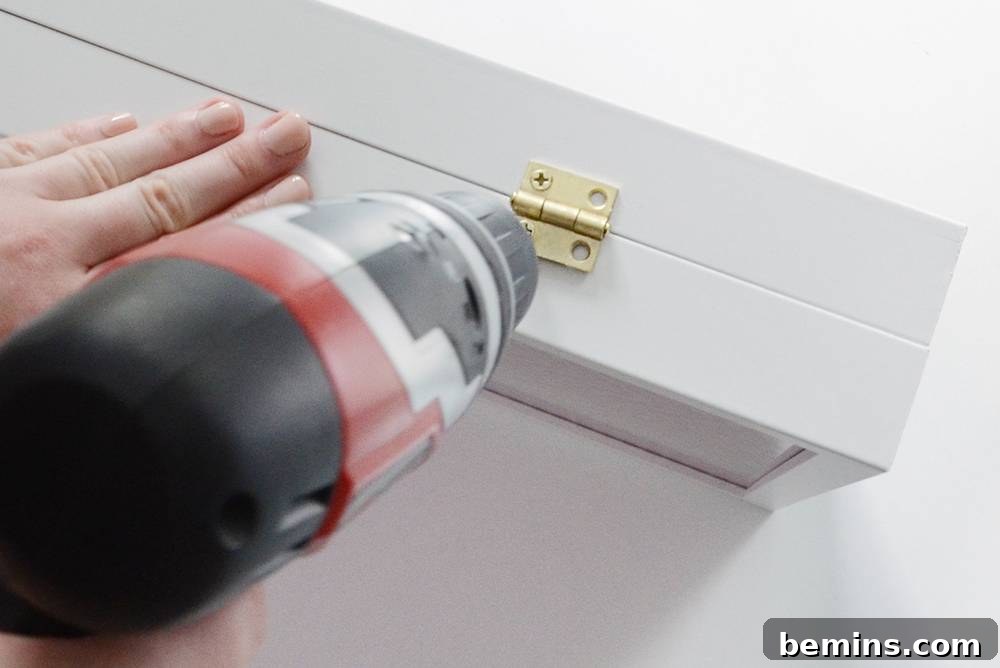 Attaching the hinges to connect the two frames