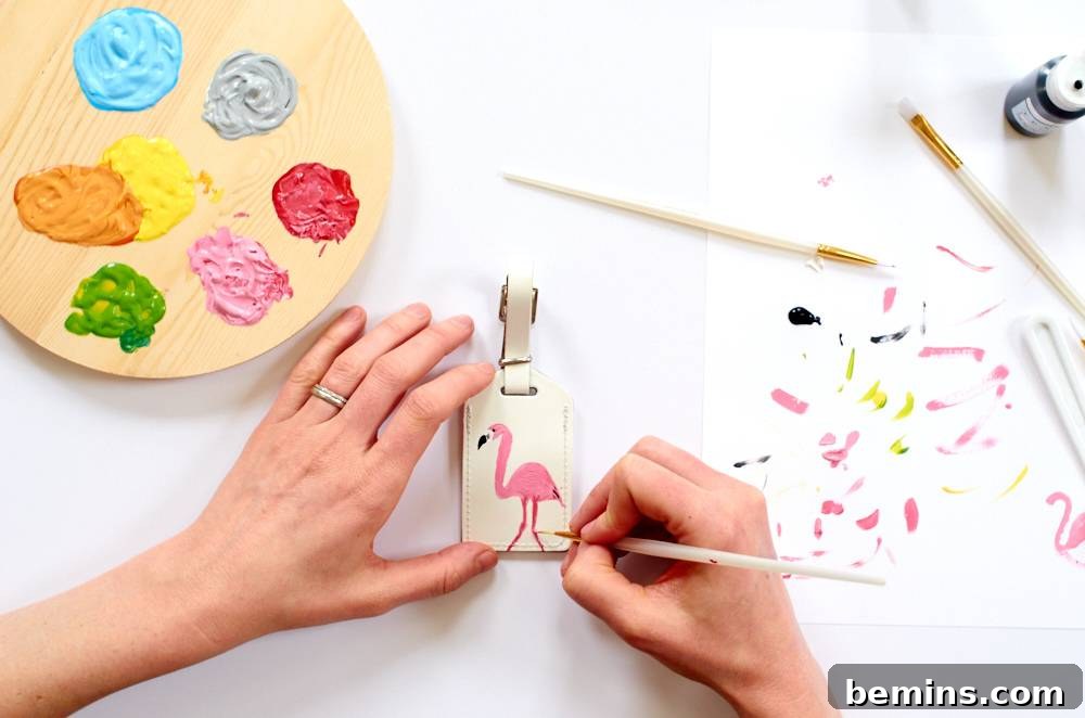 A person draws a picture of a pink flamingo. Leather luggage tags allows you to express your creativity.