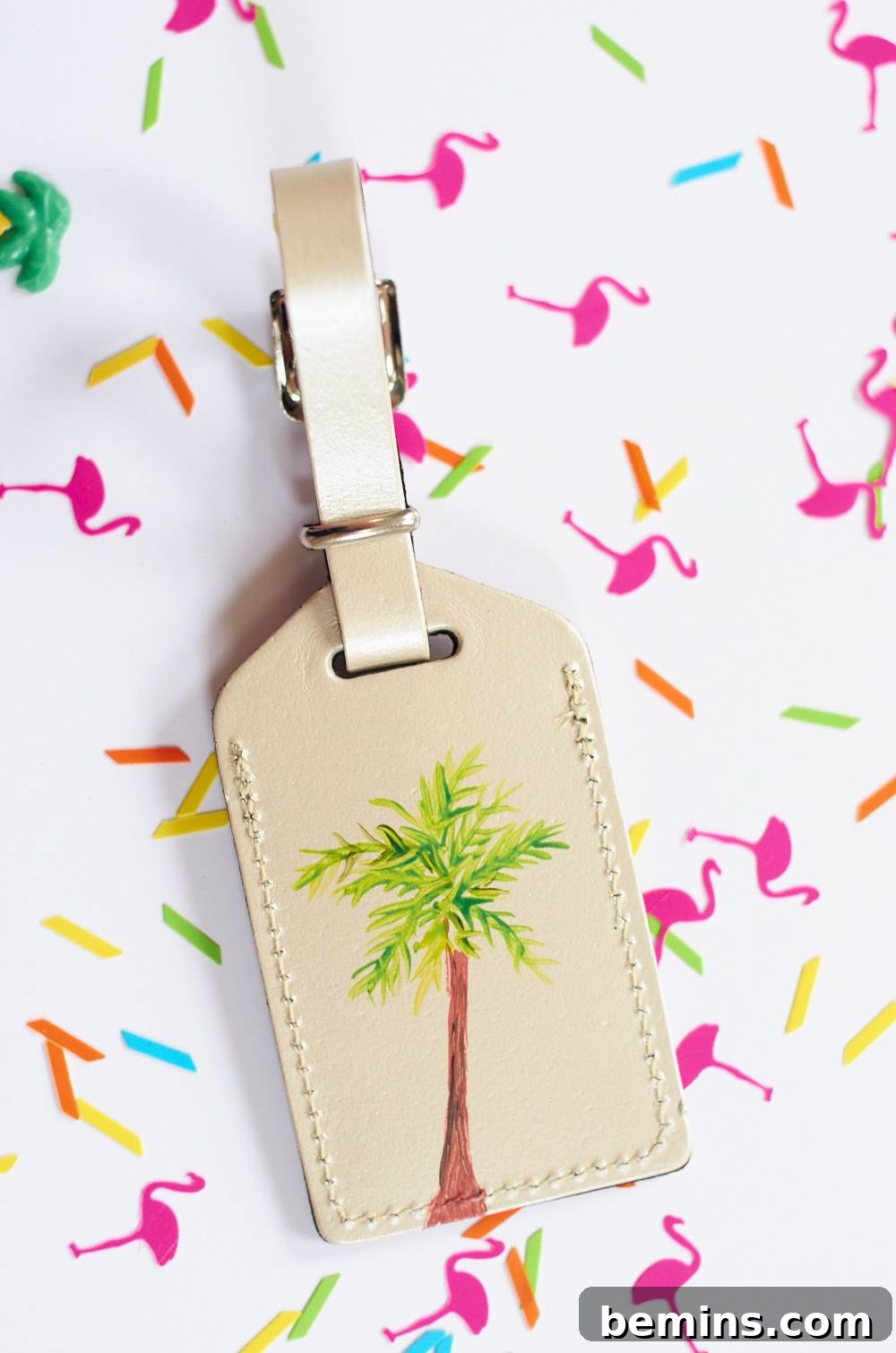 white paper sheet with a palm tree decorating picture of a pan. Use your personalized DIY luggage tags to add some personal touch to your belongings.