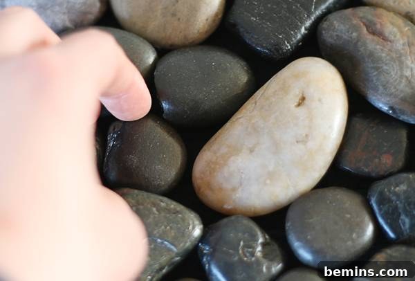 Pressing pebbles firmly onto the mat