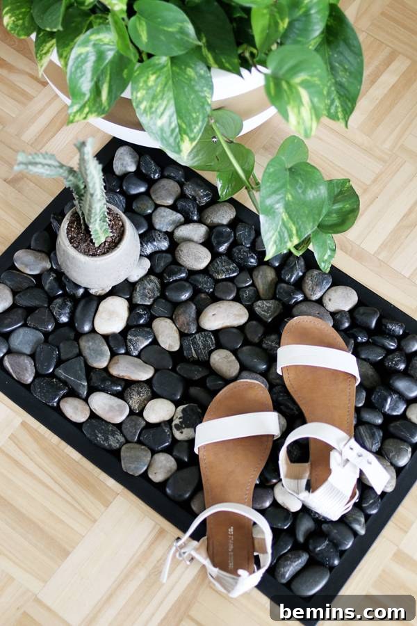 Pebble Bath Mat with plants and shoes, showcasing versatility