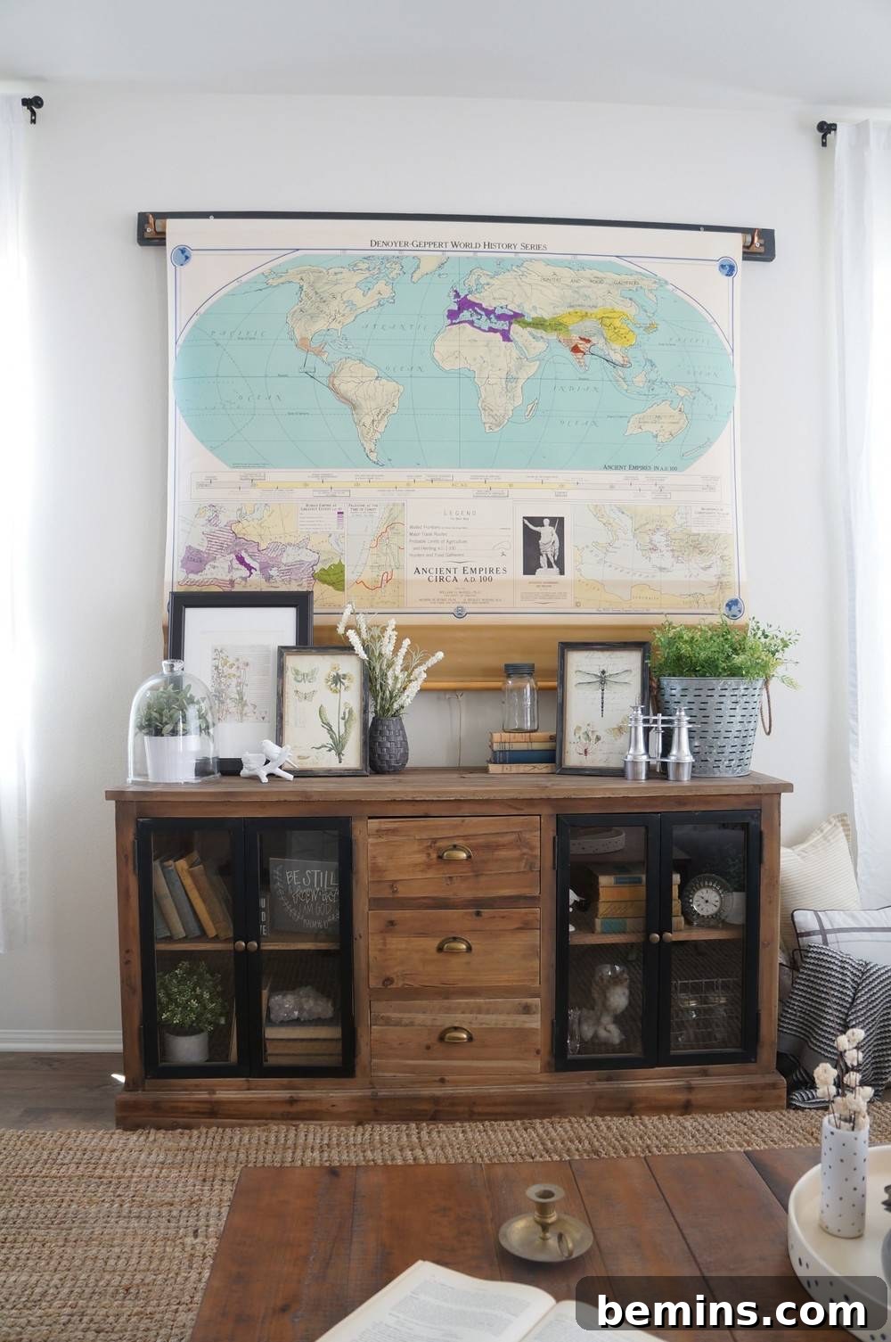 A world map concealing a TV, adding a sense of adventure and global style to the room.